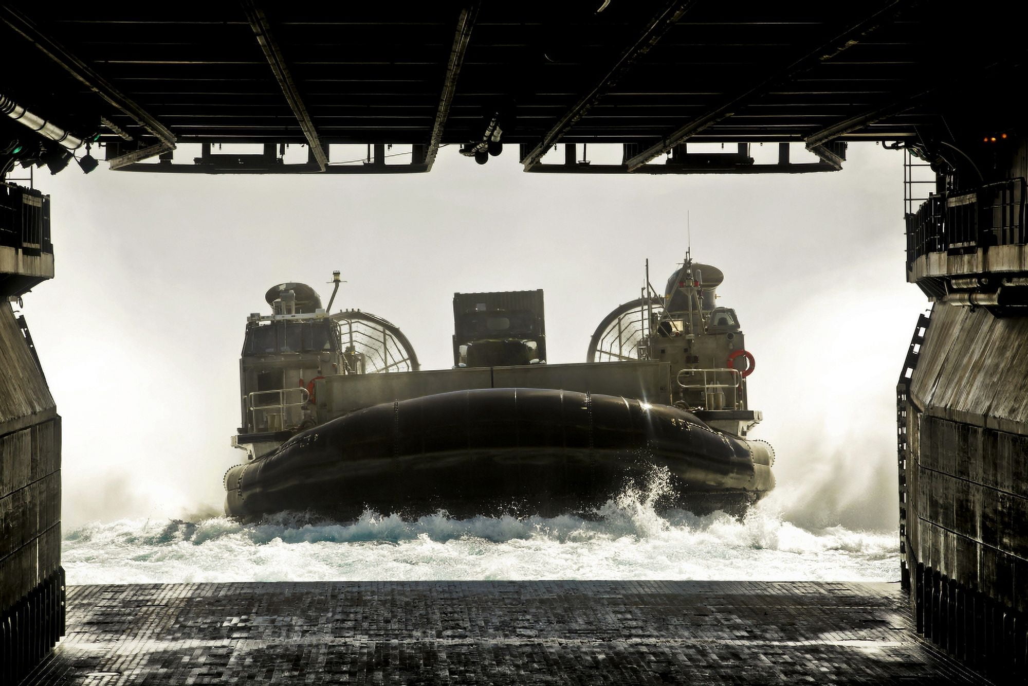 A landing craft air cushion prepares to enter the well deck of the assault ship USS Bonhomme Richard Canvas Art - Stocktrek Images (34 x 23)