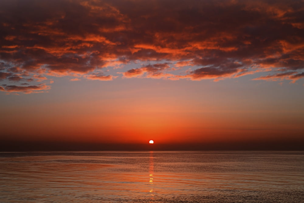 A layer of clouds is lit by the rising sun over Rio de la Plata Buenos Aires Argentina Canvas Art - Luis ArgerichStocktrek Images (17 x 12)