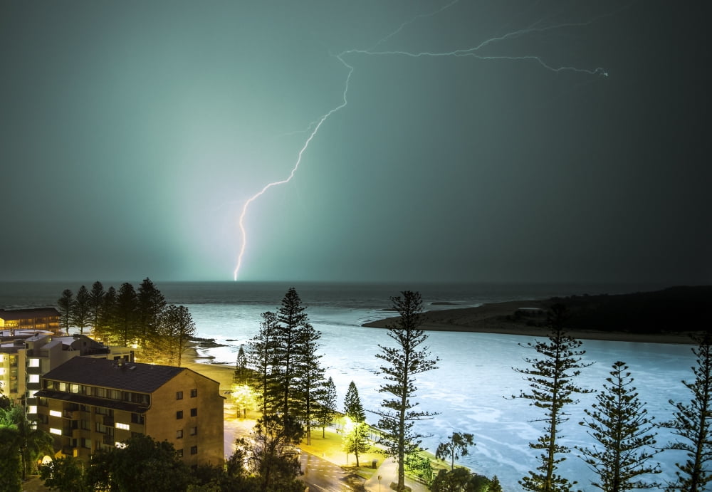 A lightning strike hits the surface of the water in the distance Brisbane Queensland Australia Canvas Art - John Short Design Pics (18 x 12)