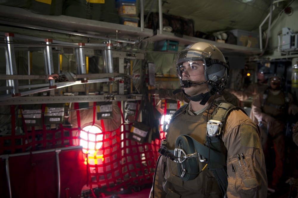 A loadmaster waits to release a load of bundles from the back of a C-130 Hercules Canvas Art - Stocktrek Images (34 x 23)