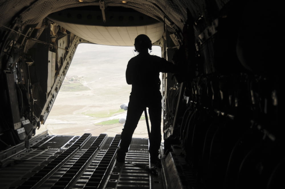 A loadmaster watches supplies airdrop out of the C-27J Spartan Canvas Art - Stocktrek Images (35 x 23)