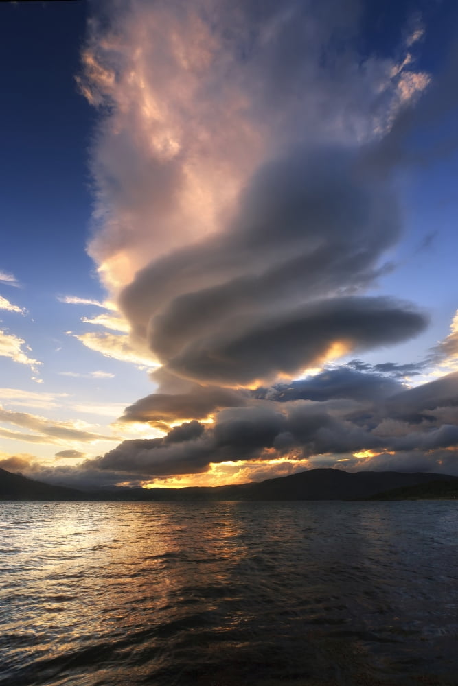 A massive stacked lenticular cloud over Tjedsundet in Troms County Norway Canvas Art - Arild HeitmannStocktrek Images (12 x 18)