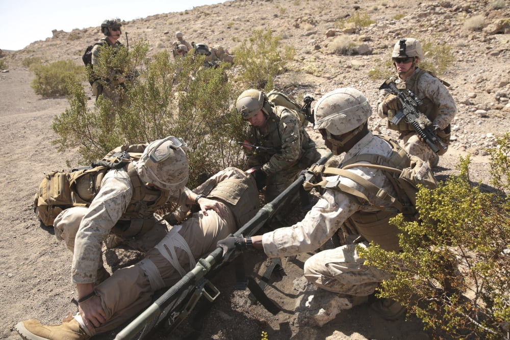 A medic treats injuries on a downed pilot alongside US Marines Canvas Art - Stocktrek Images (34 x 23)