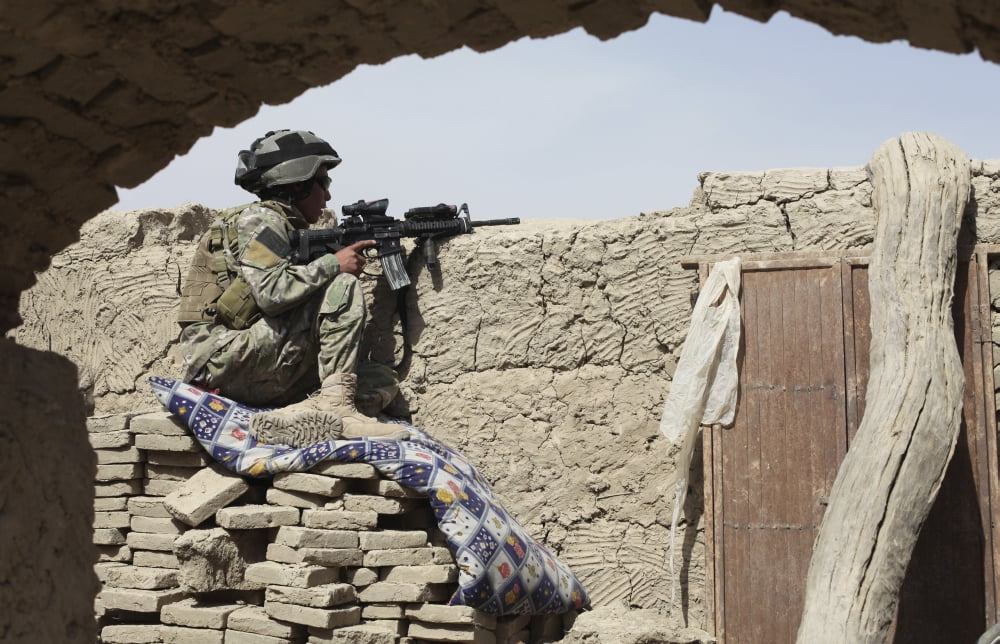 A member of an international security force secures the area in the Kandahar district of Afghanistan Canvas Art - Stocktrek Images (35 x 23)