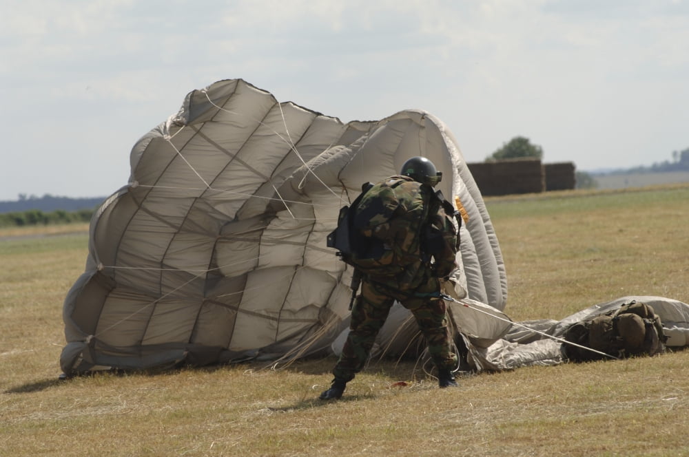 A member of the Pathfinder Platoon collapses his parachute after a HALO jump Canvas Art - Andrew ChittockStocktrek Images (34 x 23)