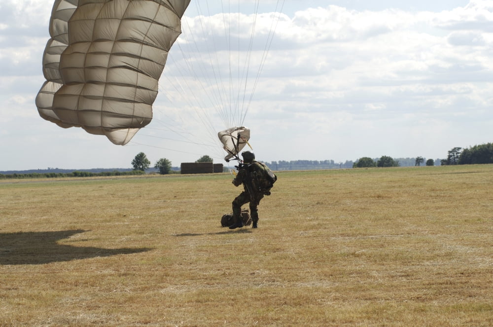 A member of the Pathfinder Platoon collapses his parachute after a HALO jump Canvas Art - Andrew ChittockStocktrek Images (34 x 23)