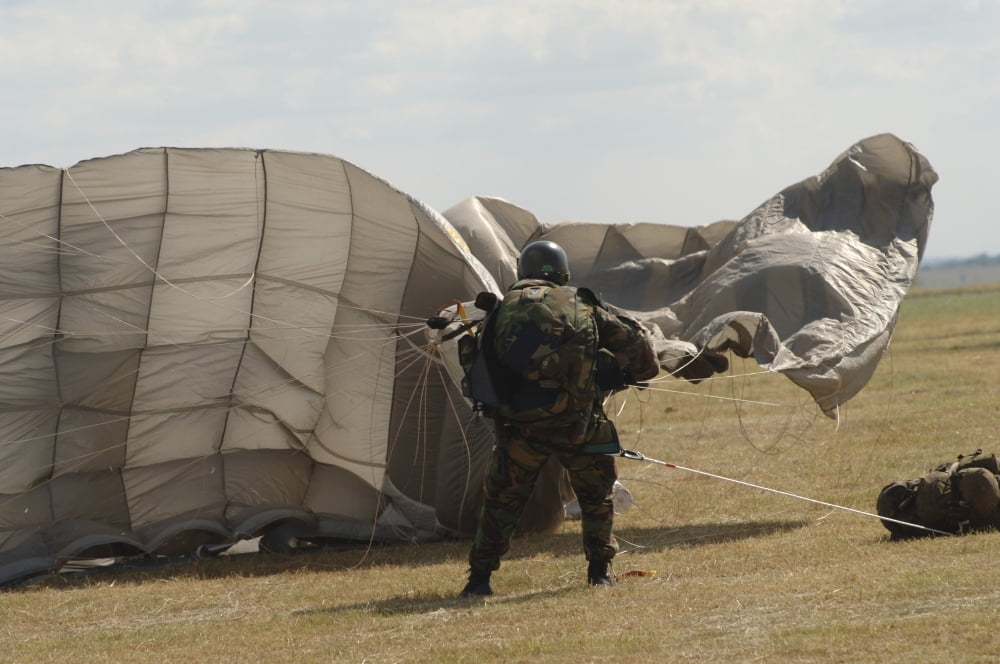 A member of the Pathfinder Platoon collapses his parachute after a HALO jump Canvas Art - Andrew ChittockStocktrek Images (34 x 23)