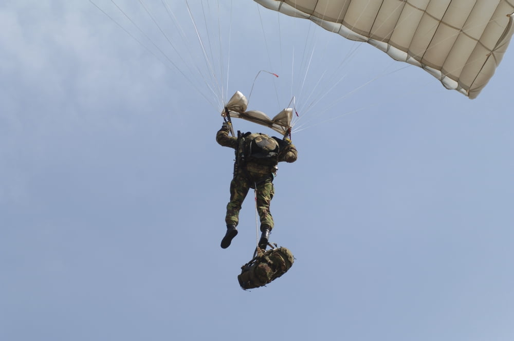 A member of the Pathfinder Platoon prepares to land from a parachute jump Canvas Art - Andrew ChittockStocktrek Images (34 x 23)