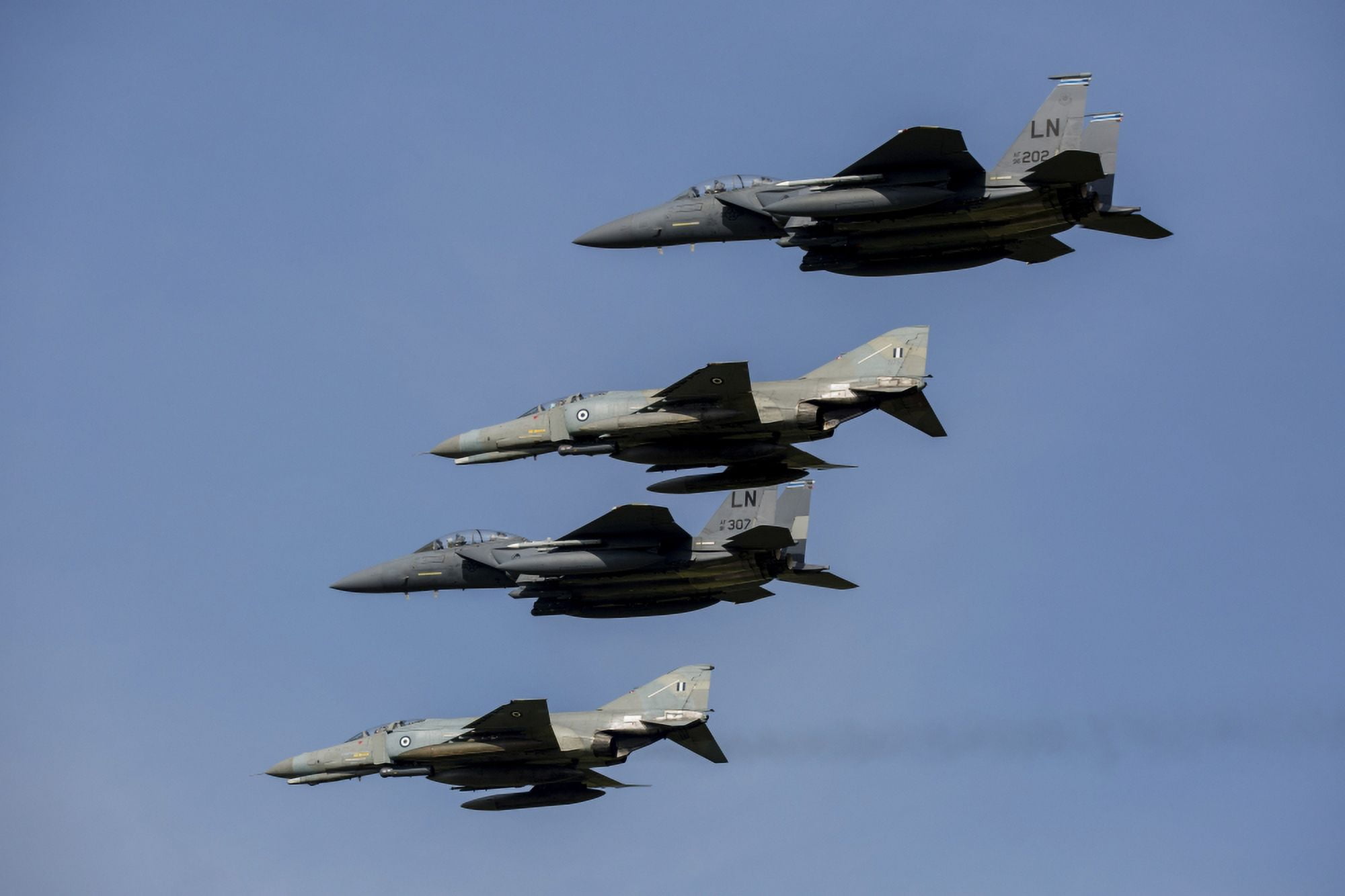 A mixed formation of US Air Force F-15E Strike Eagles and Hellenic Air Force F-4E Phantoms Canvas Art - Timm ZiegenthalerStocktrek Images (34 x 23)