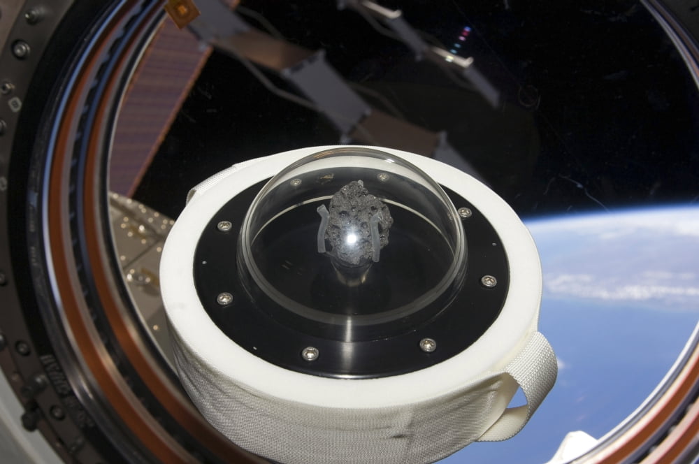 A moon rock floats aboard the International Space Station Canvas Art - Stocktrek Images (34 x 23)