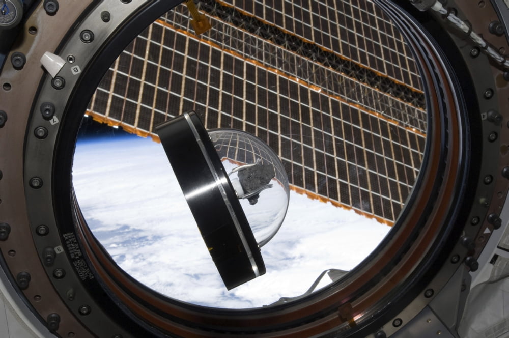 A moon rock floats aboard the International Space Station Canvas Art - Stocktrek Images (34 x 23)