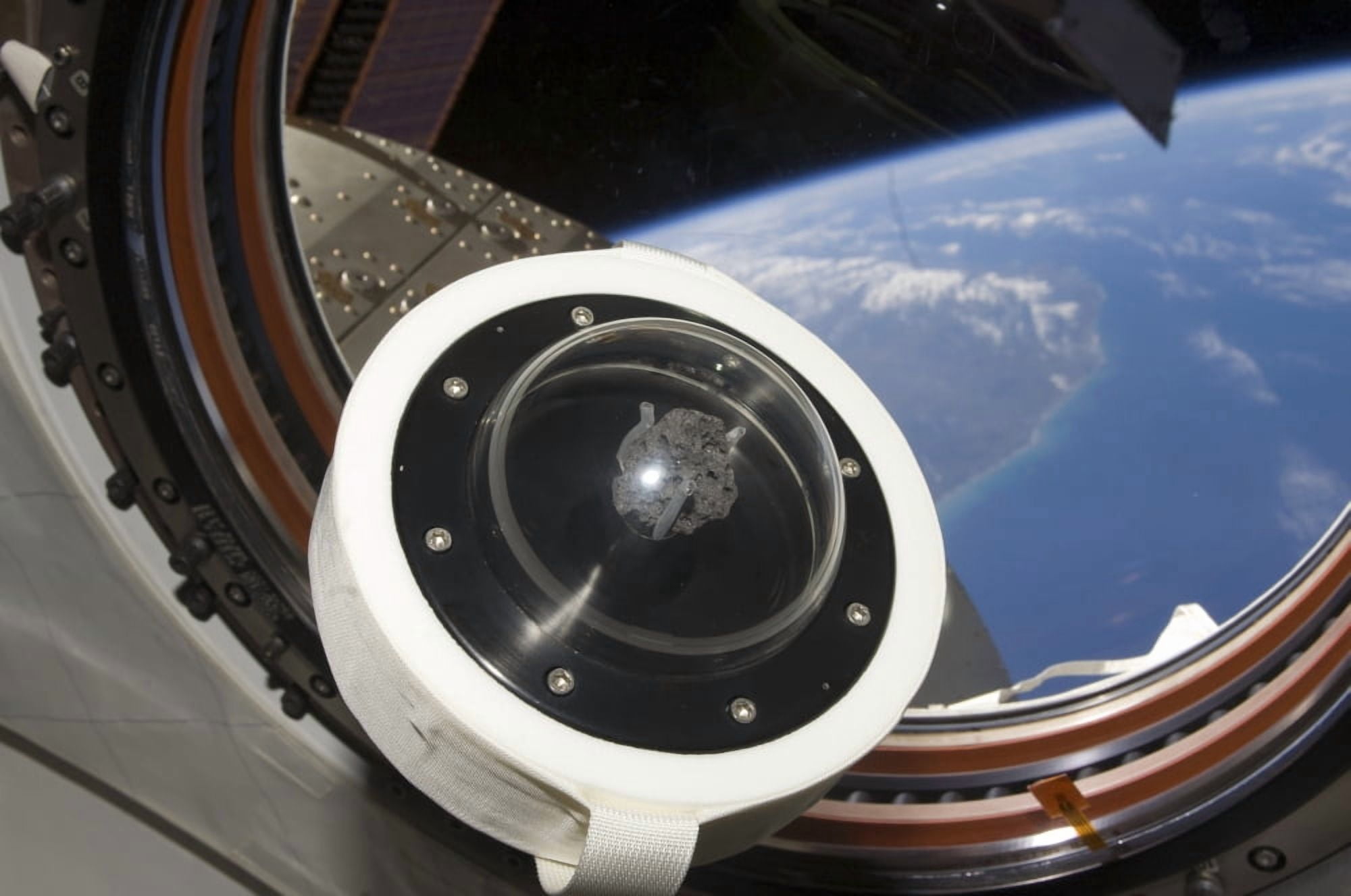 A moon rock floats aboard the International Space Station Canvas Art - Stocktrek Images (35 x 23)