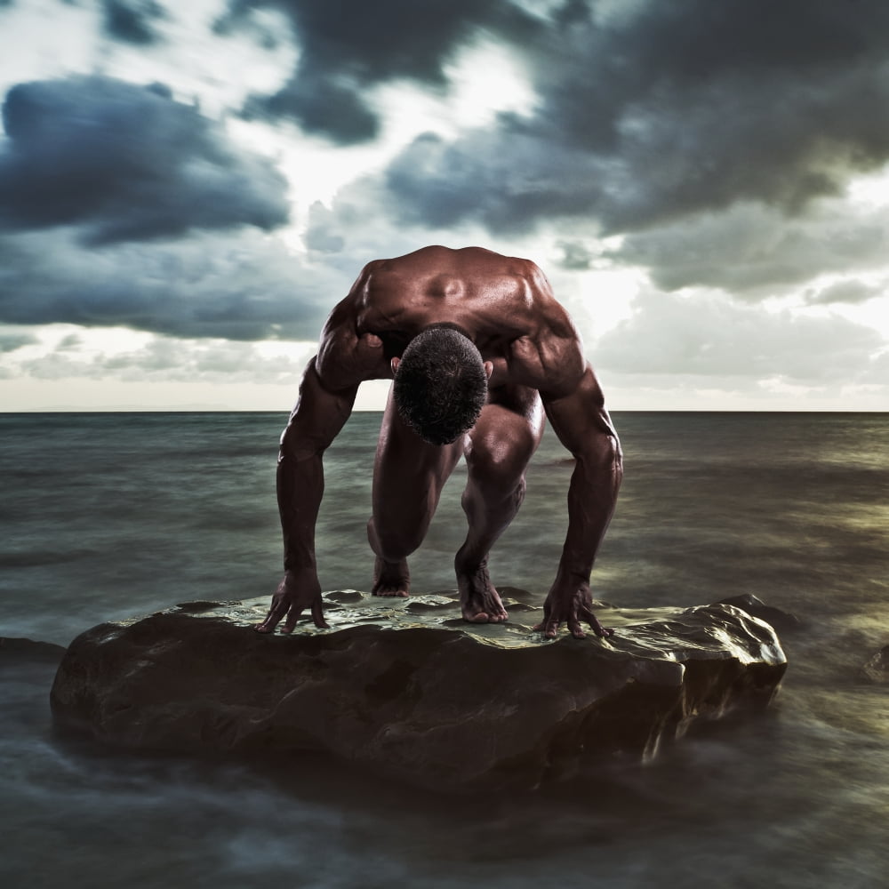 A muscular man in the starting position on a wet rock in the waterTarifa cadiz andalusia spain Canvas Art - Ben Welsh Design Pics (15 x 15)
