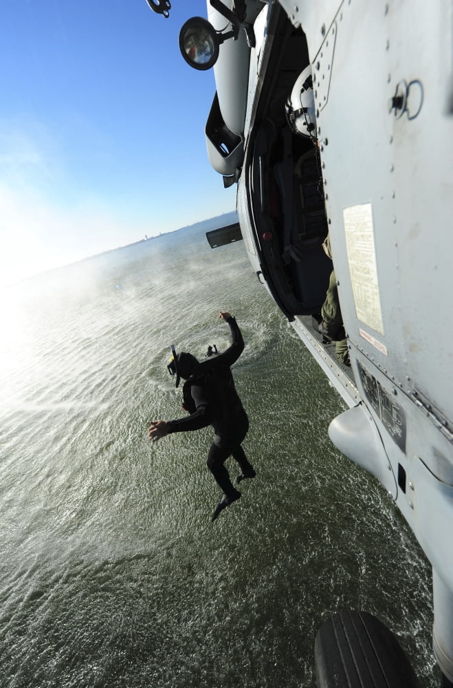 A naval air crewman jumps from an MH-60S Sea Hawk helicopter Canvas Art - Stocktrek Images (23 x 35)