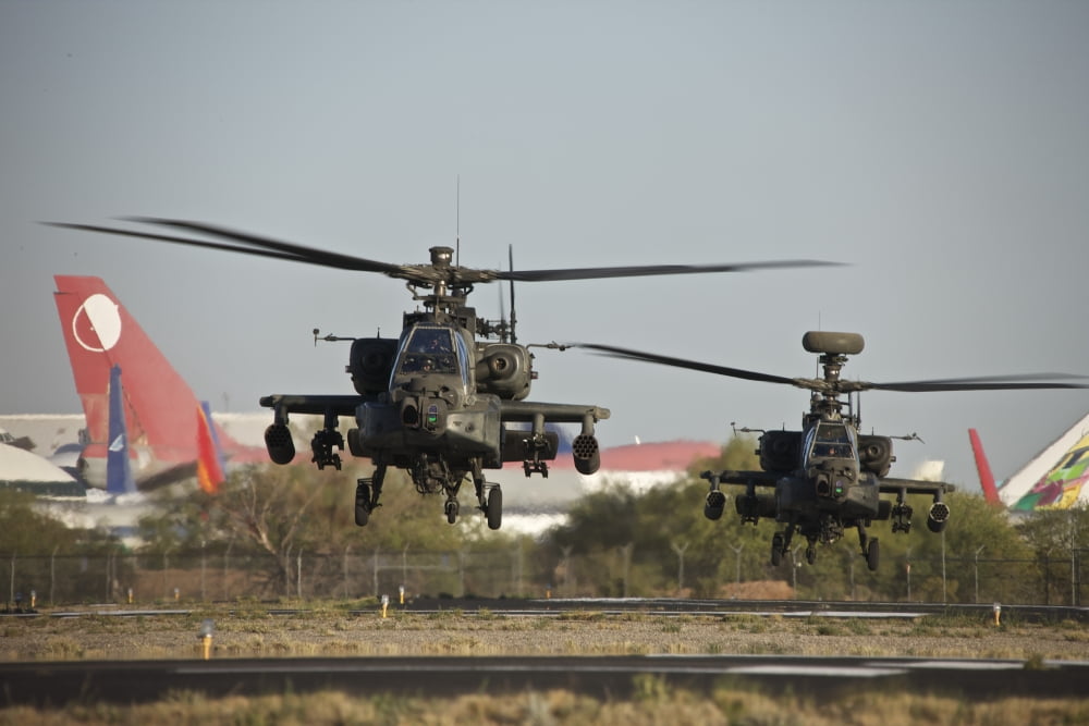 A pair of AH-64D Apache Longbow helicopters lift off Canvas Art - Terry MooreStocktrek Images (35 x 23)