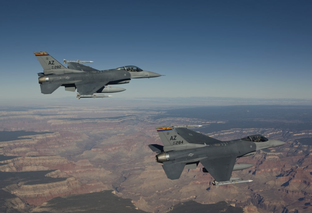 A pair of F-16s fly in formation near the Grand Canyon Arizona Canvas Art - HIGH-G ProductionsStocktrek Images (35 x 24)
