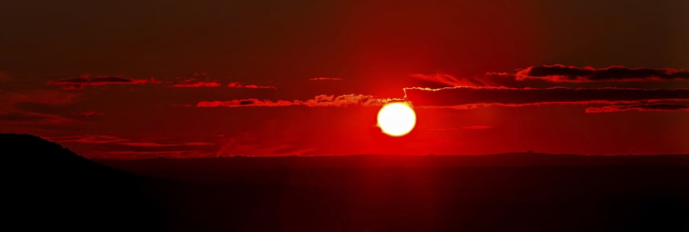 A panoramic image where clouds mimic solar prominences Canvas Art - Luis ArgerichStocktrek Images (25 x 9)