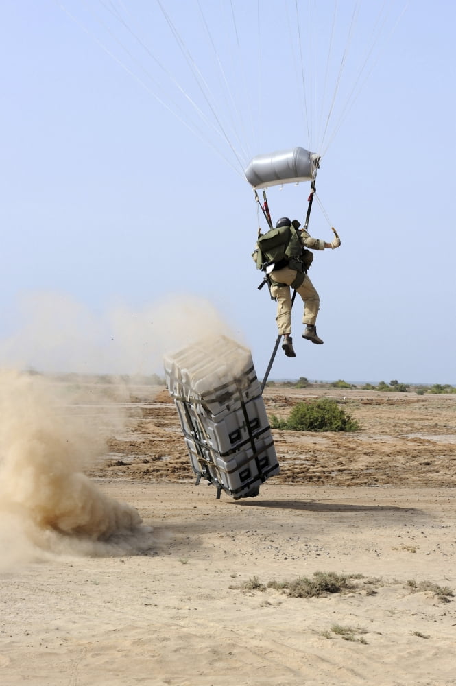A pararescueman drops into the zone trailing his teams rescue supplies outside of Camp Lemonier Djibouti Canvas Art - Stocktrek Images (23 x 34)