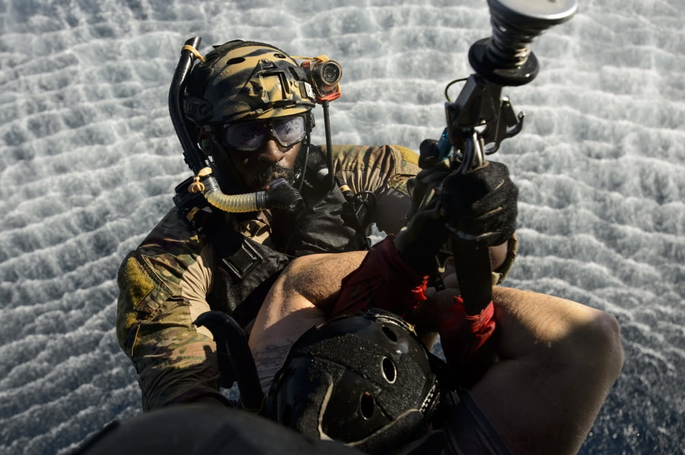 A pararescueman is hoisted into an HH-60G Pave Hawk Canvas Art - Stocktrek Images (34 x 23)