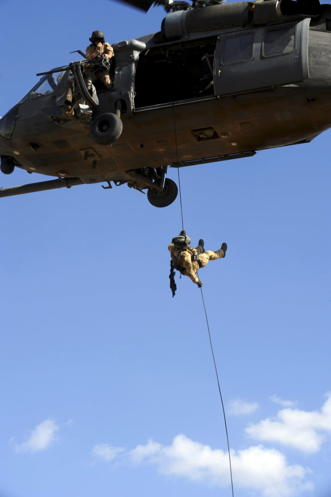 A pararescueman rappels from an HH-60 Pavehawk helicopter Canvas Art - Stocktrek Images (23 x 34)