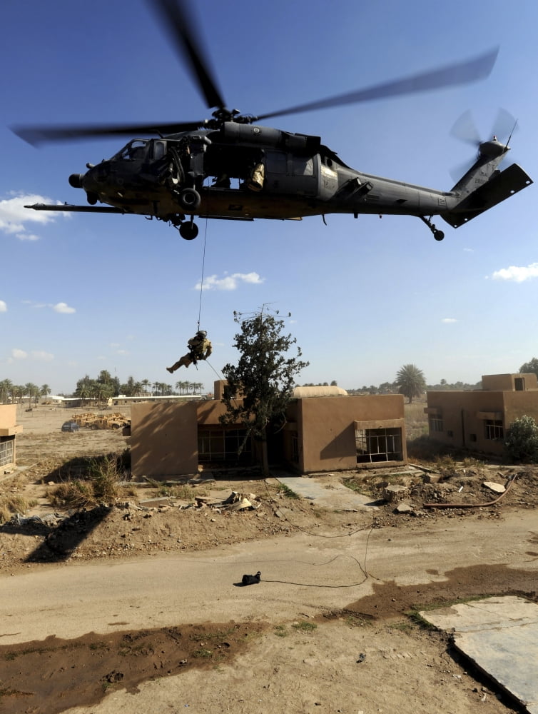 A pararescueman rappels from an HH-60 Pavehawk helicopter Canvas Art - Stocktrek Images (25 x 32)