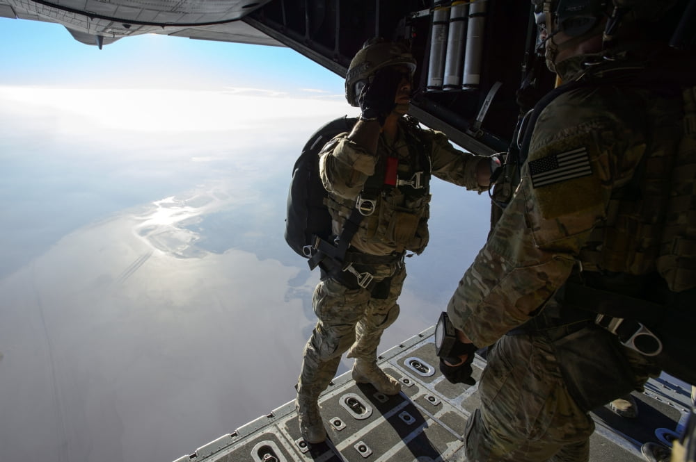 A pararescueman salutes an officer before jumping from a HC-130 Hercules Canvas Art - Stocktrek Images (34 x 23)