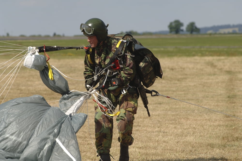 A paratrooper from the Pathfinder Platoon gathers his parachute after a training jump Canvas Art - Andrew ChittockStocktrek Images (17 x 12)