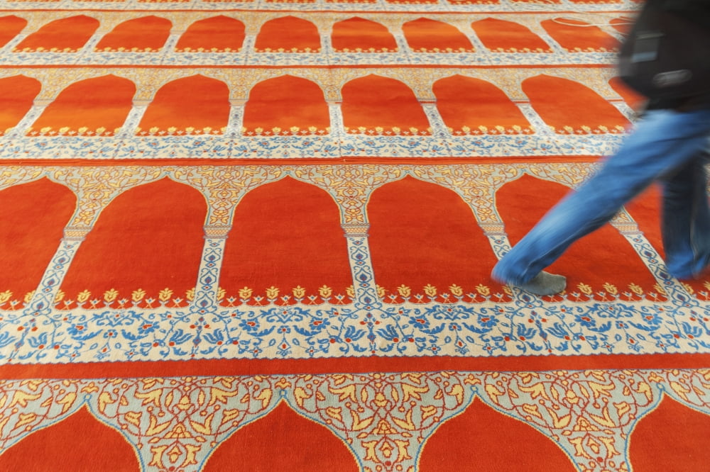 A person walking over the colourful carpet in the suleymaniye mosqueIstanbul turkey Canvas Art - Keith Levit Design Pics (19 x 12)