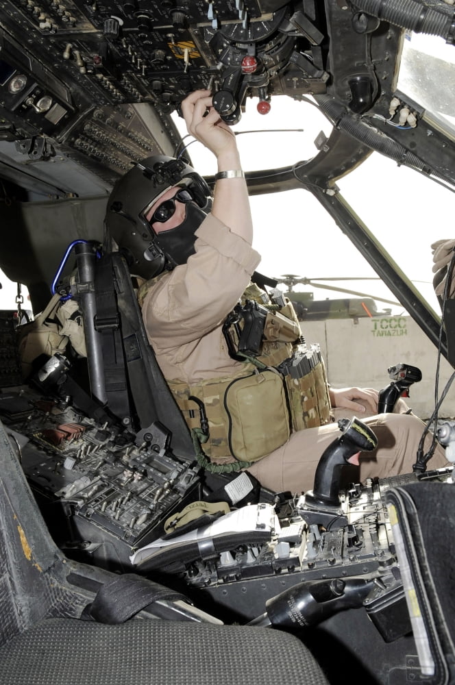 A pilot conducts preflight checks inside of a HH-60G Pave Hawk Canvas Art - Stocktrek Images (23 x 34)