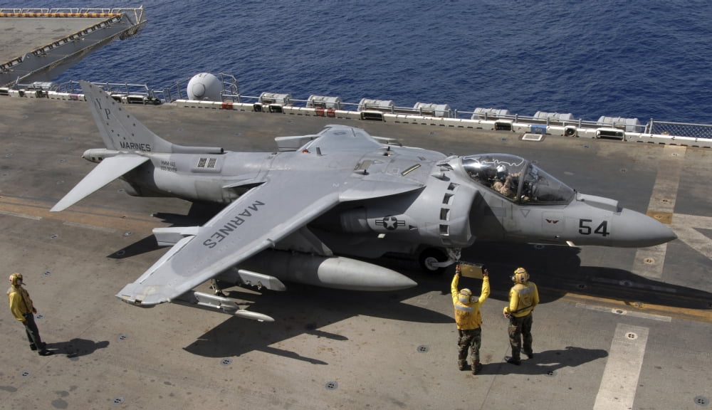 A pilot receives signals from air handlers before take-off during AV-8B Harrier flight operations Canvas Art - Stocktrek Images (38 x 22)