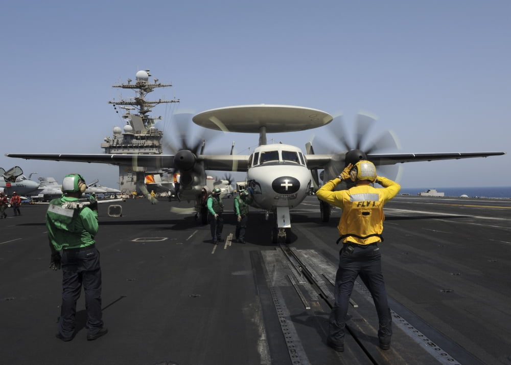 A plane director guides an E-2C Hawkeye onto the catapult for launch Canvas Art - Stocktrek Images (34 x 24)