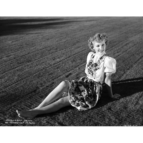 A portrait of Margaret Hayes sitting on a field Photo Print (24 x 30)
