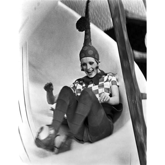 A portrait of Twiggy on a slide in an elf costume Photo Print (8 x 10)
