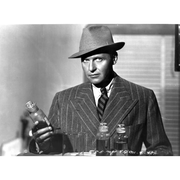 A publicity still of Ralph Bellamy holding a bottle Photo Print (8 x 10)