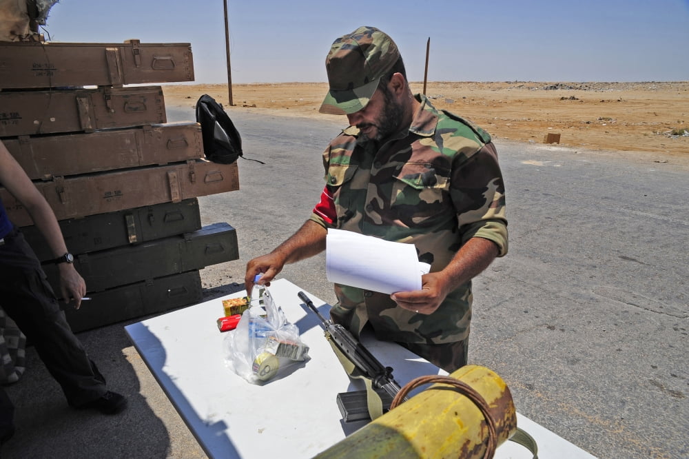 A rebel collects his food ration at a checkpoint in Ajdabiya Libya Canvas Art - Andrew ChittockStocktrek Images (35 x 23)