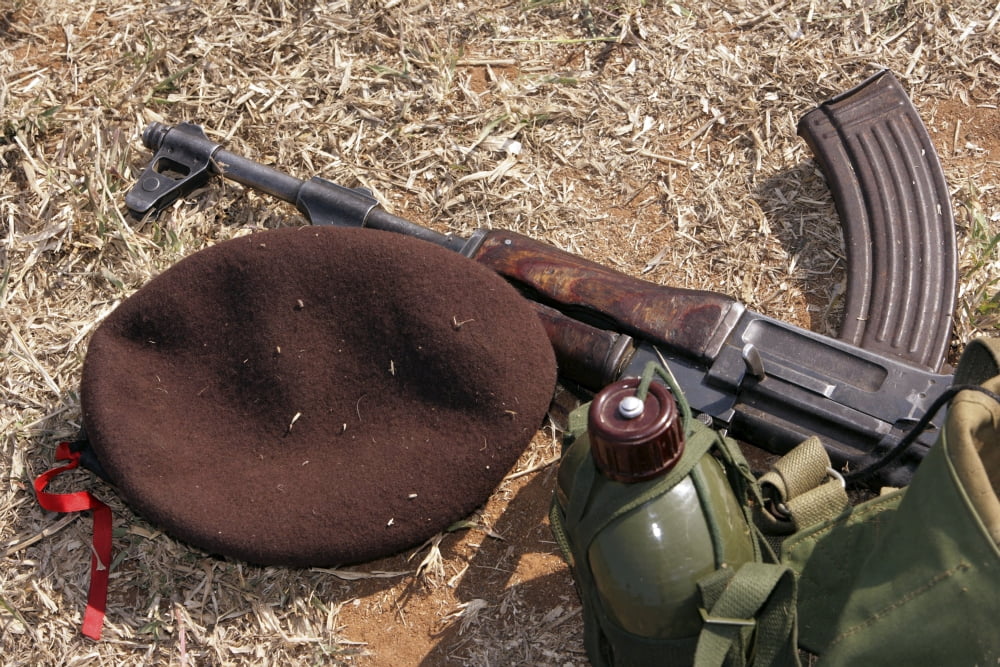 A rifle military cover and canteen of a Mozambican soldier Canvas Art - Stocktrek Images (34 x 23)