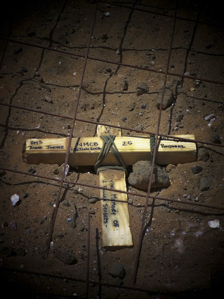 A road repair crew places a cross inside a road crater Canvas Art - Stocktrek Images (24 x 32)