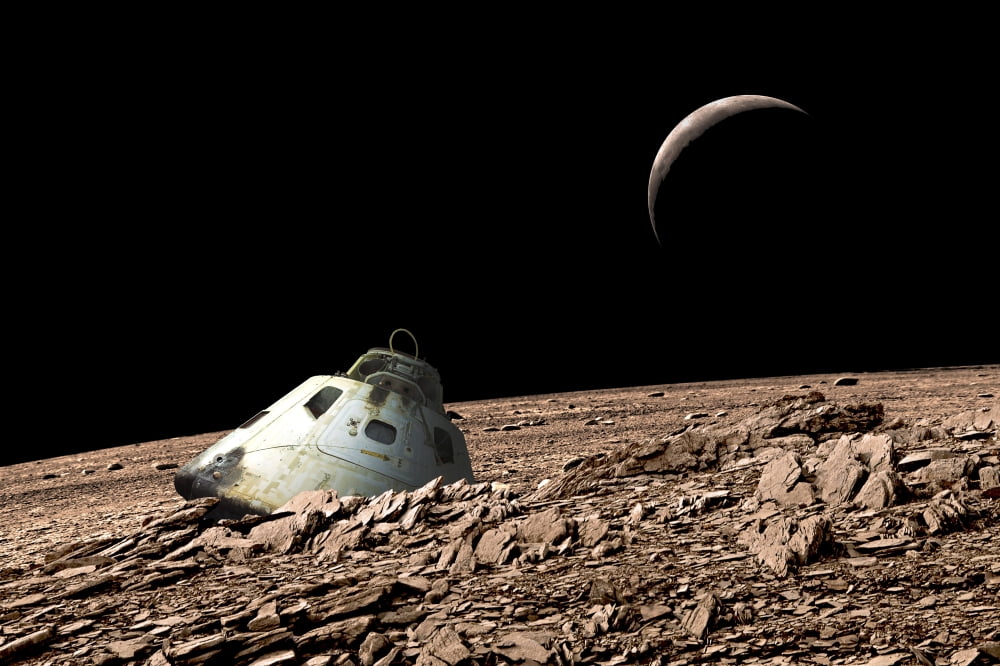 A scorched space capsule lies abandoned on a barren and airless moon Canvas Art - Marc WardStocktrek Images (34 x 23)
