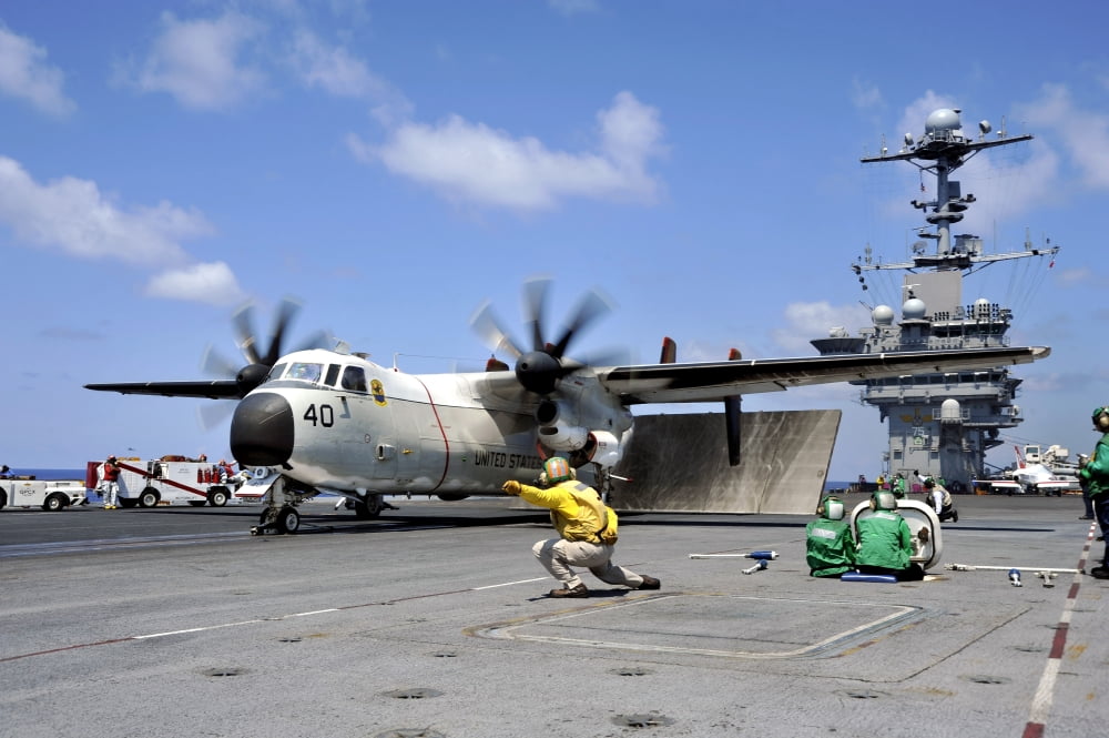 A shooter signals for the launch of a C-2A Greyhound Canvas Art - Stocktrek Images (35 x 23)