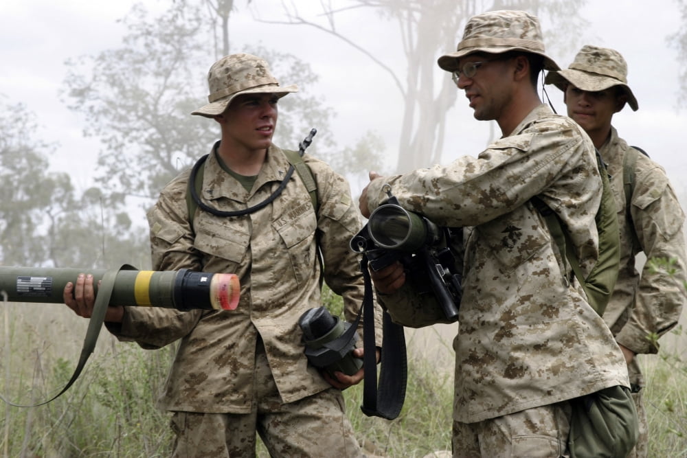 A soldier assists a mortarman as he gives a class on the use of the AT4 anti-tank weapon Canvas Art - Stocktrek Images (34 x 23)