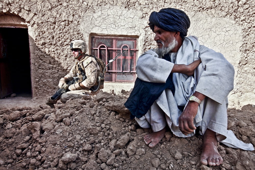 A soldier collects information from Afghan villagers during a patrol Canvas Art - Stocktrek Images (35 x 23)