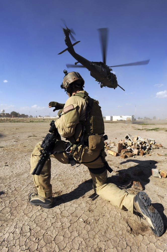 A soldier conducts security for an HH-60 Pavehawk helicopter Canvas Art - Stocktrek Images (23 x 34)