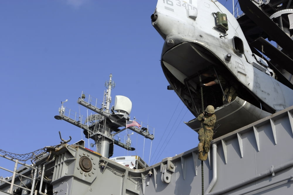 A soldier fast-ropes from the rear of a CH-46E Sea Knight Canvas Art - Stocktrek Images (34 x 23)