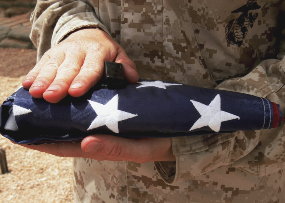 A soldier holds the United States flag Canvas Art - Stocktrek Images (33 x 24)