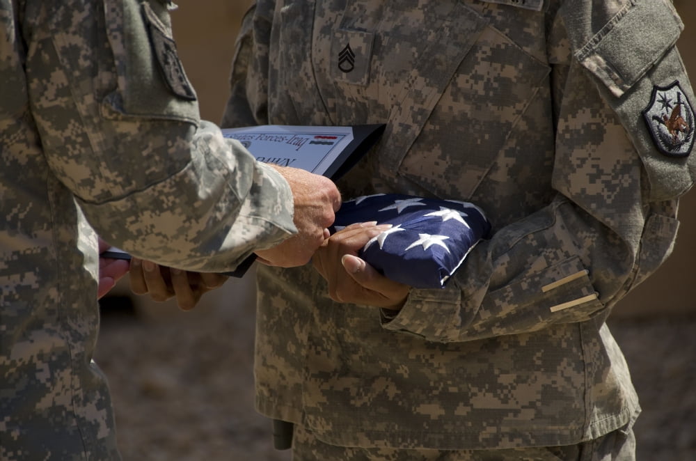 A soldier is presented the American Flag and certificate during a ceremony Canvas Art - Stocktrek Images (35 x 23)
