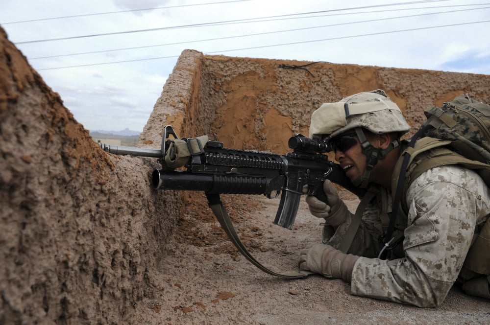 A soldier keeps watch for enemy on the roof of a building Canvas Art - Stocktrek Images (34 x 23)