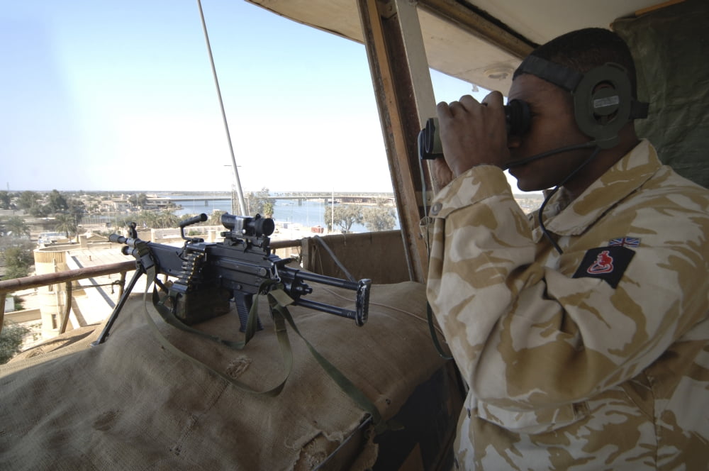 A soldier looks through binoculars from his outpost Canvas Art - Andrew ChittockStocktrek Images (34 x 23)