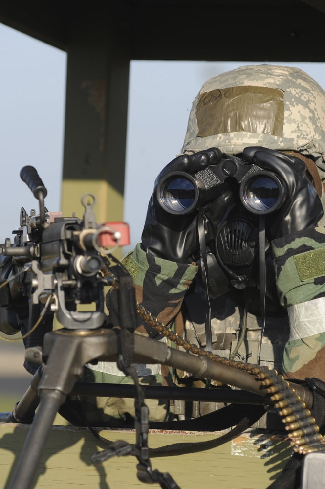 A soldier looks through binoculars from his outpost Canvas Art - Stocktrek Images (24 x 35)