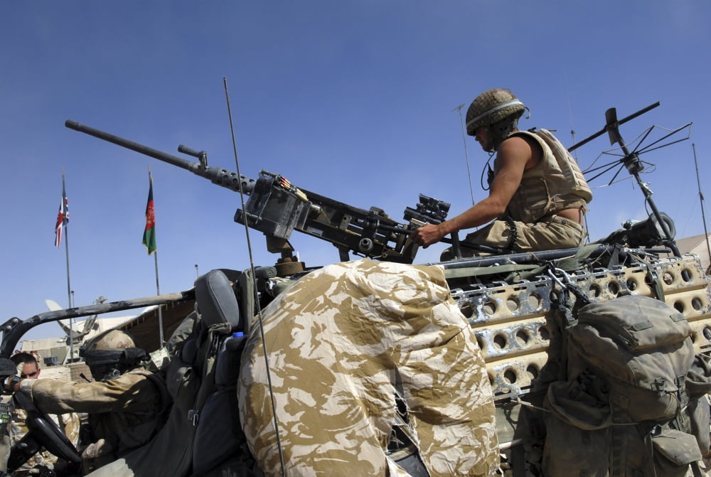 A soldier of the British Army mans a machine gun mounted on top of a land rover Canvas Art - Andrew ChittockStocktrek Images (34 x 23)