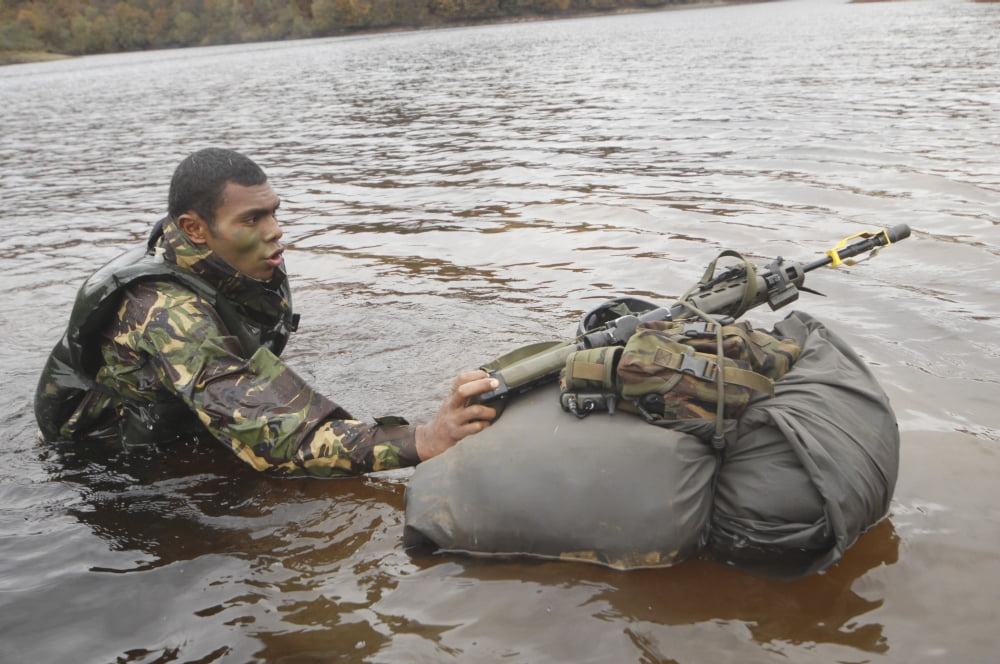 A soldier participates in a river crossing during Exercise Cambrian Patrol Canvas Art - Andrew ChittockStocktrek Images (34 x 23)